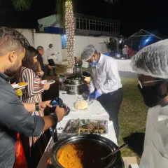 Our staff serving guests at a wedding buffet line. We ensure every guest is attended to with professional and hygienic service, allowing you to enjoy your celebration.