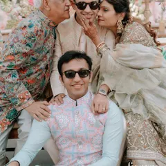 The pure joy of a family huddle during a celebration. These candid moments, full of laughter and genuine affection, are the memories we aim to preserve forever. This is a perfect example of natural family photography at events.