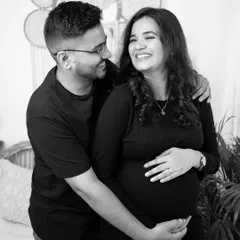A black and white photo of a couple sharing a laugh. Candid moments like this are the heart of a lifestyle session, showing your genuine connection.