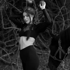 This black and white version highlights the textures and mood of the fashion collaboration, with the horse as a key element.