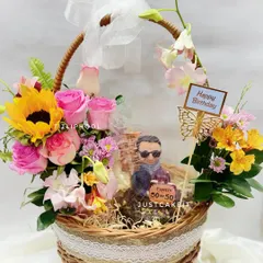 A perfect gift for a 50th birthday, this hamper combines a custom half-figurine cake with a stunning fresh flower basket. The client wanted a cream-free cake, so I made a rich chocolate walnut base.