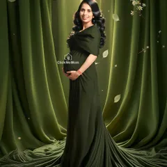 A portrait of pure elegance in a rich, olive green gown. The soft draping of the fabric and the classic studio lighting create a sophisticated and timeless look, highlighting the serene glow of motherhood.