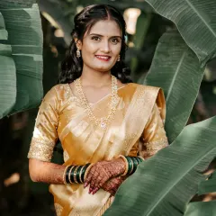 The same beautiful bride in a different outfit, her traditional mehendi looking stunning with her golden silk saree and Maharashtrian jewelry.