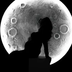 A powerful silhouette against our glowing moon prop. This creative shot captures the wonder and magic of pregnancy in a unique and artistic way.