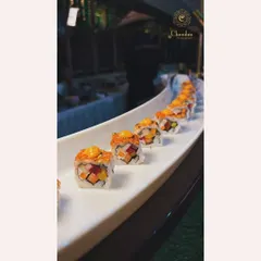 A long platter of our signature sushi rolls, showcasing the fresh ingredients and vibrant colors. My Pan-Asian station is always a hit.