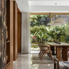 We believe homes in Bangalore should breathe. Here, the dining space seamlessly opens up to a lush, landscaped garden. By using large sliding doors, we made the outdoors an integral part of the dining experience, creating a beautiful, ever-changing backdrop for family meals and gatherings.
