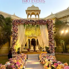 A classic floral mandap against the backdrop of a heritage property. The aisle is lined with dense pastel blooms, creating a romantic and fragrant path for the bride's entrance.
