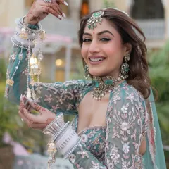A happy bride radiates joy in our exclusive designer pastel lehenga. The unique blouse design and delicate floral embroidery make this a standout piece, perfect for making memories.