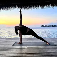 Extended Side Angle Pose, or Parsvakonasana, with the ocean as my backdrop. This pose creates a long line of energy from the back foot to the fingertips, stretching the entire side of the body.