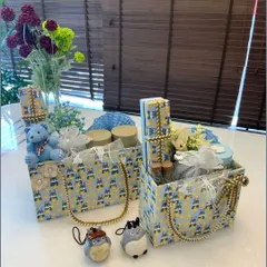 Our 'A Touch of Blue, A Bundle of Joy' hampers designed for a baby boy. These tote-style gift boxes feature a charming blue and yellow pattern and are filled with coordinated items to welcome the little one.
