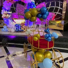As part of the welcome celebration, I decorated this beautiful golden pram with balloons. It serves as a wonderful prop for photos and the baby's grand entrance.