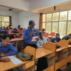 A participant at Toyota Kirloskar confidently speaks into the microphone, demonstrating the progress made during our English communication workshop. Our goal is to build both skills and confidence.