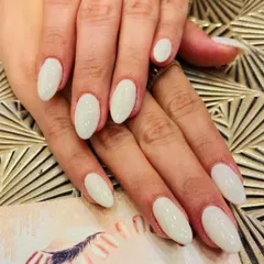 A clean and simple set of almond-shaped nails in a solid, milky white color. This versatile look is modern, chic, and goes with everything.