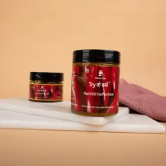 Jars of Red Chilli Stuffed Pickle presented on a marble slab, with simple styling to keep the focus on the product.