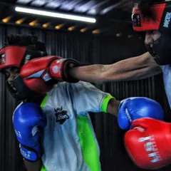 You will get hit. Here, two of our young boxers are in a controlled sparring session, learning to trade punches and think under pressure. This is how you build resilience.