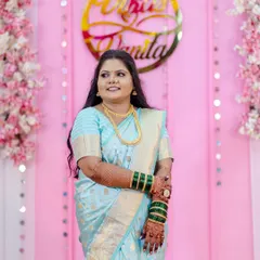 A beautiful candid shot of the client during her engagement ceremony. Her makeup gives her a natural glow, and her hair is styled in soft waves, creating a look that is both elegant and modern.