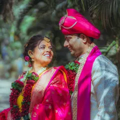 The beautiful, vibrant colors of a traditional Maharashtrian wedding. Here, Pratiksha and Nitesh share a sweet glance, surrounded by lush greenery. I love capturing the unique cultural details and bright emotions of every ceremony.