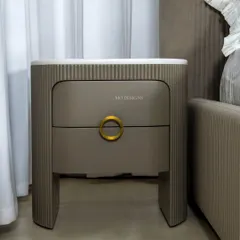 The Greco Side Table is the perfect companion to our Greco Bed. It features a pristine white onyx top and a taupe-colored wood base with meticulous fluting, creating a harmonious and rhythmic effect that complements the bed's design.