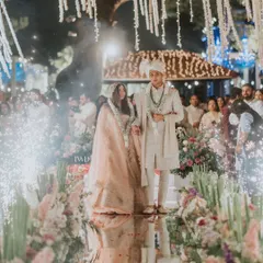 Imagine walking on water towards your forever. We designed this stunning mirror aisle, reflecting a thousand lights and the love of family, creating a magical path for the couple's journey together under a canopy of jasmine.