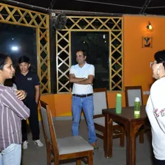 A candid moment of discussion and relaxation during a training camp. We provide a space for riders and families to connect and share their experiences.