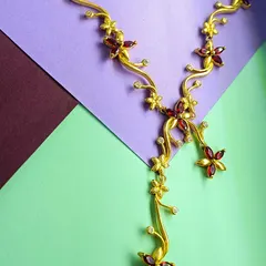 Another angle of the gold-plated red floral necklace, showing how the design gracefully drapes around the neck.