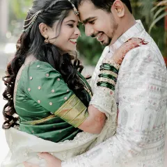 A lovely couple portrait from their engagement day. The bride's glowing makeup and traditional green saree look beautiful next to the groom's elegant attire.