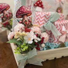 A close-up of the fairy garden details in the six-month hamper, showing the faux florals, mushroom cutouts, and delicate ribbons that bring the theme to life.