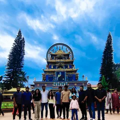 A corporate team stands before the magnificent Namdroling Monastery. My itineraries often include cultural sightseeing to provide a well-rounded and enriching experience.