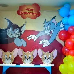 Another look at the Tom & Jerry Nerf shooting booth, decorated with colorful balloons and a vibrant backdrop.