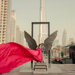 Taking romance international with a pre-wedding shoot in Dubai. My vibrant rani pink satin gown with its flowing trail stands out beautifully against the iconic city skyline. We can ship your dream gown anywhere.