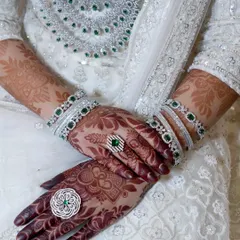 A posed shot highlighting the beautiful henna stain and the bride's elegant rings and bangles.