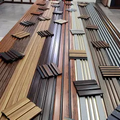 This table is laid out with over 50 different designs of our fluted charcoal panels. You can see the variety of textures, colors, and patterns available to create a sophisticated look for your interiors.