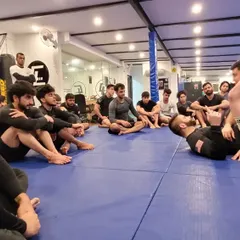 A close-up view of a triangle choke being set up. In our seminars, everyone gets a clear view of the mechanics, ensuring no detail is missed.