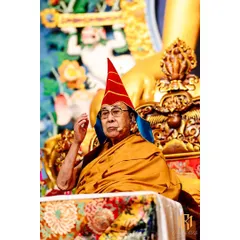 A close-up portrait of His Holiness the Dalai Lama during a teaching session in Bodh Gaya. Capturing such moments requires anticipation and discretion, ensuring the sanctity of the event is maintained while documenting its key figures.