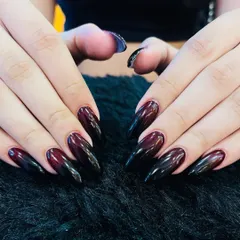 Dark and dramatic. This look features a seamless ombré blend from a deep burgundy to black on long, almond-shaped nails. The glossy finish makes the colors look rich and intense.