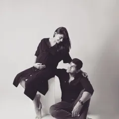 A beautifully composed black and white shot of the couple. The different levels and loving looks create a dynamic yet intimate portrait that feels both artistic and authentic.