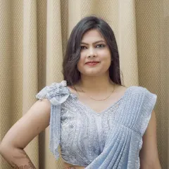 A closer portrait in the same silver saree, focusing on the model's expression and the blouse detailing.