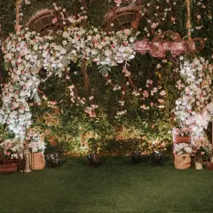 We created an enchanting garden setting for this post-wedding soiree. The floral arch, set against a wall of lush greenery, served as a beautiful photo backdrop and focal point for the evening's celebrations.