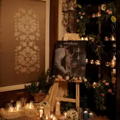 A romantic and personalized corner for an engagement party. We set up an easel with the couple's photo, surrounded by a sea of candles, strings of pearls, and delicate floral arrangements.