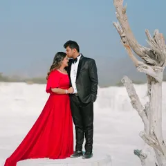 An intimate and tender portrait of the groom kissing his bride's forehead. The stark, beautiful landscape adds a unique and dramatic flair to this romantic moment.