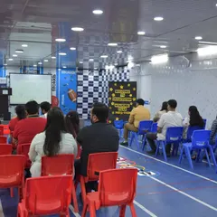 Another view of our spacious indoor area during a parent event. The hall is equipped with a stage and screen, making it ideal for various functions.