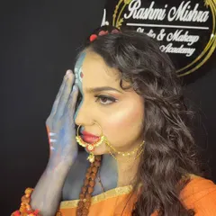 This pose highlights the hand makeup and the dramatic winged liner, key elements of this powerful look.