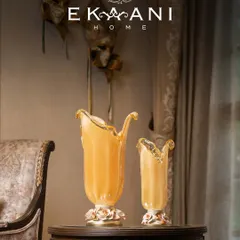 This pair of Murano glass vases, with their unique organic shapes and porcelain rose bases, showcases the quiet drama of Venetian heritage. No two pieces are ever the same, each carrying the delicate fingerprint of its maker.