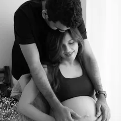 A loving kiss on the head. This intimate black and white image is a beautiful testament to the couple's bond and the journey they are on together.