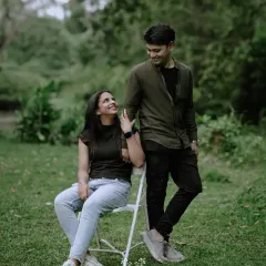 A playful and natural portrait of the couple in a park, capturing their easy-going chemistry.