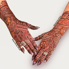 A full and intricate back-hand design. The mix of floral, paisley, and geometric patterns creates a rich texture that is perfect for a bride.