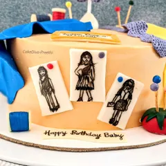 A close-up of the fashion designer cake, showing the hand-painted fashion sketches on edible paper. These little details are what make a personalized cake truly special.