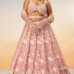 Another view of the pastel pink lehenga, this time with elegant gloves, showing how you can style it for a unique look.