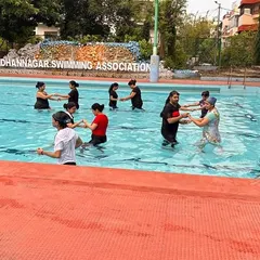 The group holds hands and moves together in the water, showcasing the fun and social aspect of my aqua fitness classes.