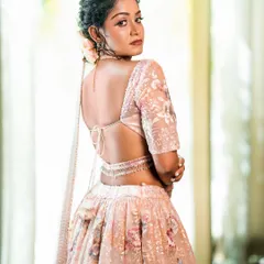 This shot from the back highlights the design of the blouse and the flow of the sheer dupatta, showing the garment's full 360-degree appeal.